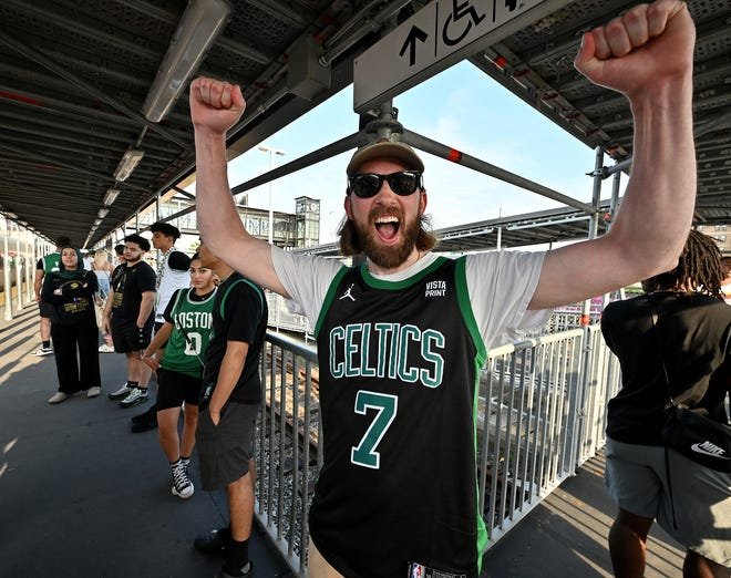 Luke Pottle of Worcester waits to board the train at Union Station early Friday morning to watch the Celtics championship parade in Boston.